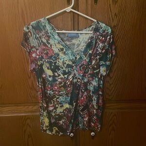 Multi colored abstract floral top with asymmetrical neckline